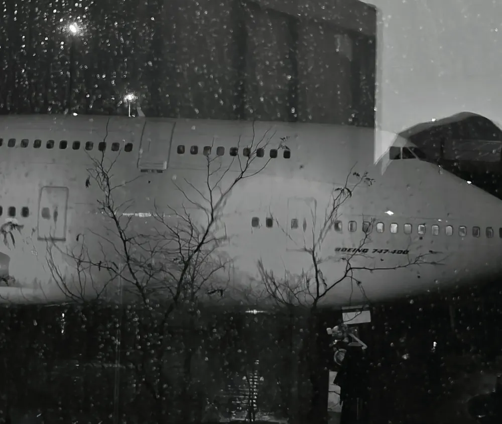 A parked wide-body passenger aircraft, in black and white