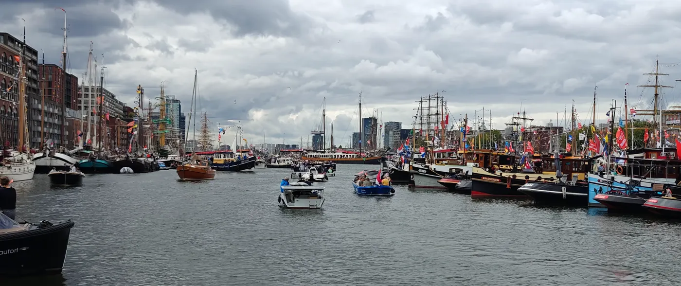 Tall ships and small boats moored during harbour week in Amsterdam